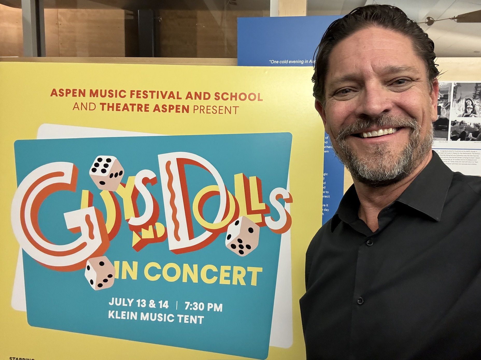 Mircea Oprea standing in front of Guys and Dolls production of Aspen Music Festival and School and Theatre Aspen marquee 071326 in Aspen, CO