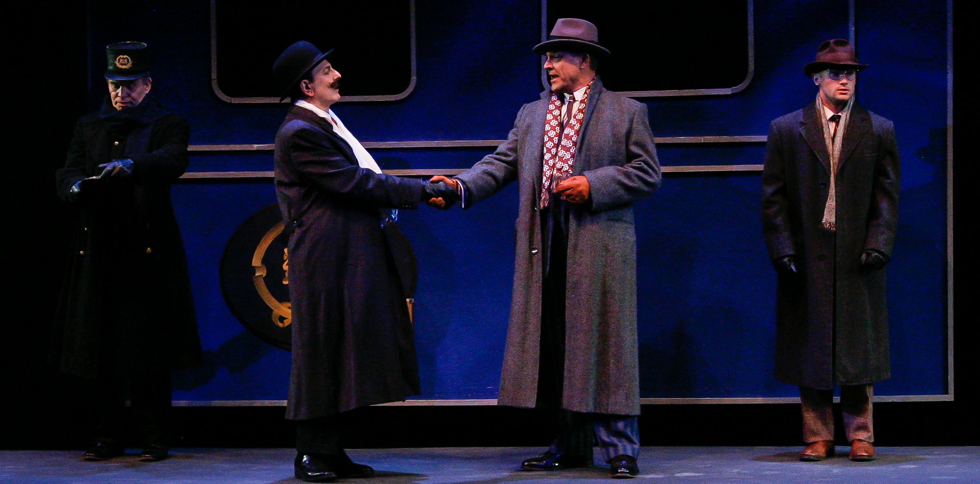 Samuel Ratchett (Mircea Oprea) has a proposition for Hercule Poirot (Matthew Tavianini) while Michel, the Conductor (Raymond Wallenthin) and while Hector MacQueen (Johnny Waaler) looks on in Murder on the Orient Express at the Garvin Theatre - Santa Barbara, CA photo by Pam Lasker